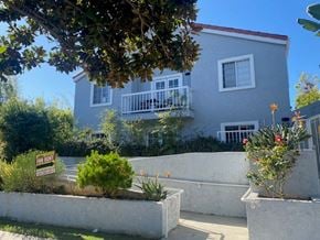 Santa Monica apartment for rent - A house with a balcony and a tree in front.
