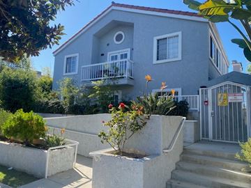 Santa Monica apartment for rent - A house with a grey exterior and a red roof with a white fence and a gate.