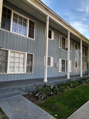Los Angeles apartment for rent - A grey house with white trim and a small garden in front.