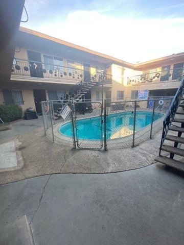 Gardena apartment for rent - A pool surrounded by a fence in a courtyard.