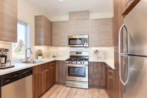 Petaluma apartment for rent - a kitchen with stainless steel appliances and wooden cabinets  at Addison Ranch Apartments, Petaluma, CA