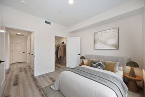 Folsom apartment for rent - A bedroom with a large bed and a painting on the wall.