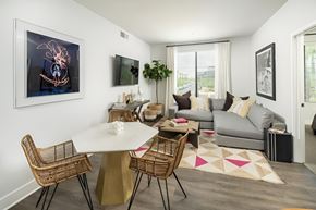 Phoenix apartment for rent - A modern dining room with a white table and chairs.