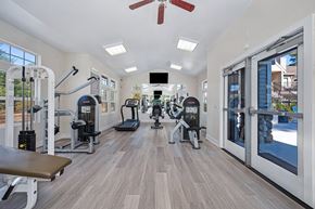 Citrus Heights apartment for rent - A gym with a variety of equipment including treadmills, weights, and a bench at Hidden Oaks Apartments, Citrus Heights, California