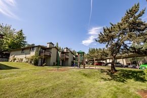 Kent apartment for rent - Property grounds showing green grass , play structure and apt
