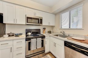 Davis apartment for rent - Kitchen with White Cabinets, Oven, Microwave, Window and Dishwasher at Silverstone Apartments, Davis, California