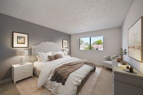 Lancaster apartment for rent - A well-lit bedroom with a large bed and a window showing a view of the outdoors.