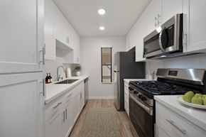 Lancaster apartment for rent - A modern kitchen with white cabinets and stainless steel appliances.