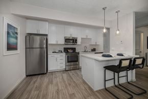 Davis apartment for rent - a kitchen with white cabinetry and stainless steel appliances at Pinecrest Apartments, Davis ,95616