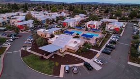 Petaluma apartment for rent - an aerial view of a building with a large solar panel on the roof at Addison Ranch Apartments, Petaluma, CA