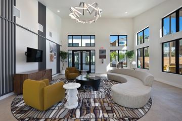 Folsom apartment for rent - A modern living room with a patterned rug and a chandelier.