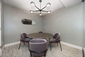 Sacramento apartment for rent - a meeting room with a table and chairs and a chandelier  at Track 281 Apartments, California, 95811
