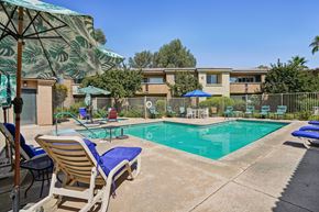 Palm Desert apartment for rent - our apartments have a resort style pool with chairs and umbrellas