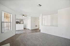 Palm Desert apartment for rent - an empty living room with white walls and a kitchen