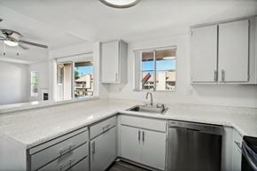 Palm Desert apartment for rent - a row of windows in a white building with light shining through them