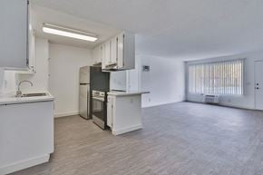 San Diego apartment for rent - A kitchen with white cabinets and a refrigerator.