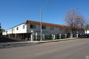 Vista apartment for rent - A street view of a building with a red tile roof.
