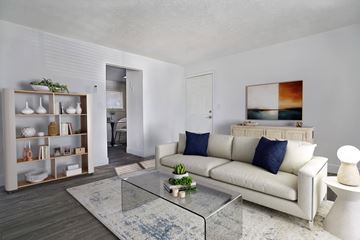 Salt Lake City apartment for rent - A modern living room with a white couch and a glass coffee table.