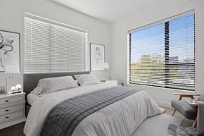 Salt Lake City apartment for rent - a bedroom with a large bed and two windows