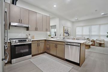 Salt Lake City apartment for rent - A modern kitchen with a stainless steel refrigerator and a white oven.