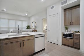 Salt Lake City apartment for rent - A modern kitchen with a white countertop and brown cabinets.