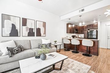 Salt Lake City apartment for rent - A modern living room with a grey couch and a white coffee table.