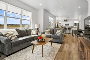 Lehi townhouse for rent - A modern living room with a grey couch and a coffee table.