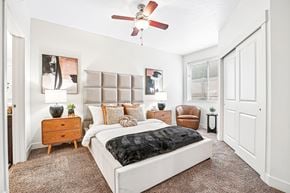 Salt Lake City apartment for rent - A bedroom with a large bed and a ceiling fan.