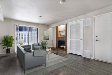 West Valley City apartment for rent - A living room with a grey couch and a fireplace.