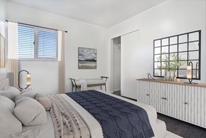 Ogden townhouse for rent - A bedroom with a large bed and a painting on the wall.