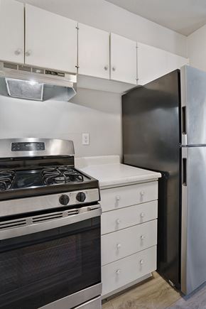 West Valley City apartment for rent - A black refrigerator stands next to a stove in a kitchen.