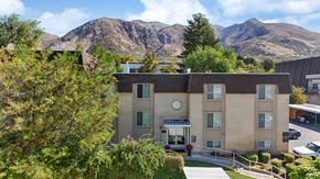 Ogden apartment for rent - A building with a mountain in the background.