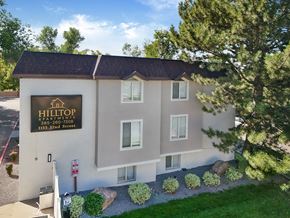 Ogden townhouse for rent - A building with a sign that says Hilltop Apartments.