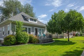 Logan apartment for rent - a house with a large lawn and trees in front of it