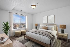 Park City condo for rent - A bedroom with a large bed and a window with a view of the outside.