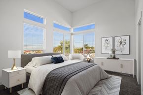 Ogden townhouse for rent - a bedroom with a large bed and three large windows