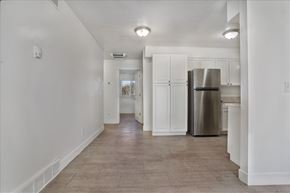Ogden apartment for rent - A kitchen with white cabinets and a stainless steel refrigerator.