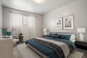 West Valley City apartment for rent - a bedroom with a bed and two pictures on the wall