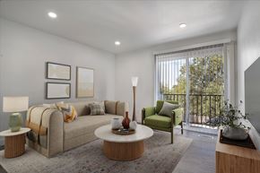 Ogden townhouse for rent - A living room with a couch, a chair, a table, and a lamp.