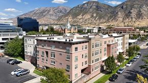 Provo apartment for rent - A large building with a parking lot in front of it.