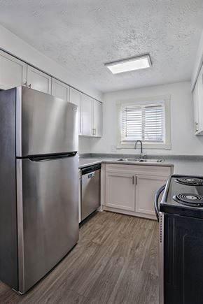 Salt Lake City apartment for rent - A modern kitchen with a stainless steel refrigerator and wooden flooring.
