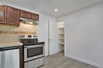 Ogden townhouse for rent - A kitchen with a stove top oven and a microwave.