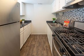 West Valley City apartment for rent - a kitchen with stainless steel appliances and a stove top oven