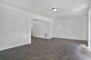 Ogden townhouse for rent - A spacious room with wooden flooring and white walls.