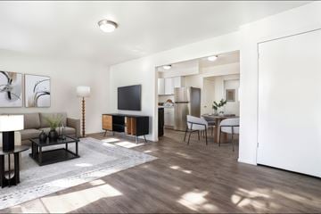 Ogden townhouse for rent - A modern living room with a brown sofa and a grey rug.