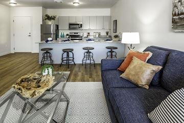 Slc apartment for rent - a living room with a couch and a glass table