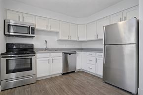 Salt Lake City apartment for rent - A kitchen with a stainless steel refrigerator, oven, and microwave.