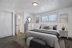 Salt Lake City apartment for rent - A bedroom with a large bed and a mirror on the wall.