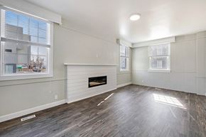 Clearfield apartment for rent - an empty living room with white walls and a fireplace