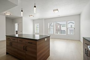 Ogden apartment for rent - A kitchen with wooden cabinets and a black countertop.
